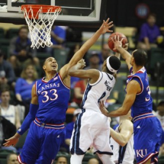 Landen Lucas (33) and Perry Ellis (34) block a shot of a Rhode Island player in the Jayhawks' 76-60 win.