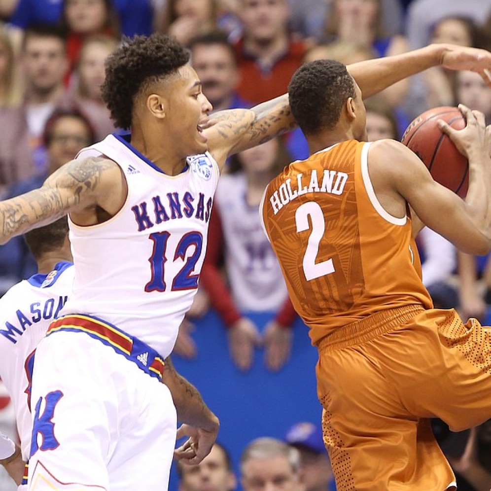 Kelly Oubre Jr. trys to get his hands on the ball as Demarcus Holland drives to the hoop in Kansas' 69-64 win over Texas