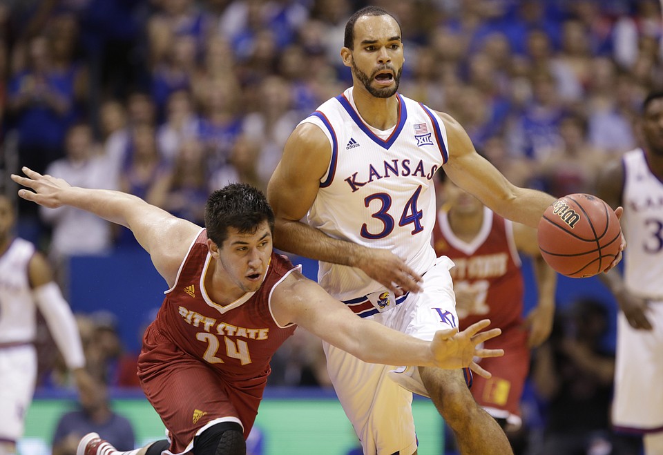 Pittsburg State forward Trevor Gregory (24) reaches as Kansas forward Perry Ellis (34) drives up the court during the first half on Wednesday, Nov. 4, 2015 at Allen Fieldhouse. Photo by Nick Krug